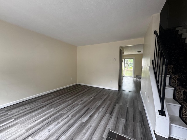 148 Westbury Park Rd Apt D, Watertown, CT 06795 - unfurnished room featuring wood finished floors, stairs, and a baseboard radiator