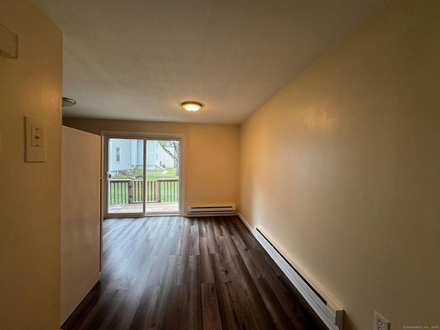 148 Westbury Park Rd Apt D, Watertown, CT 06795 - empty room featuring baseboard heating and dark wood finished floors