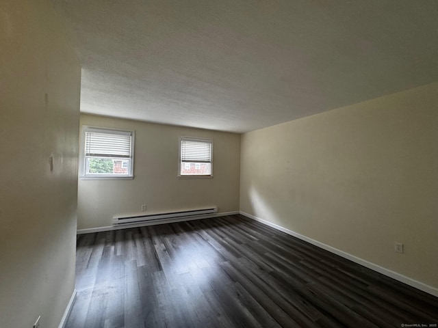 148 Westbury Park Rd Apt D, Watertown, CT 06795 - empty room featuring a baseboard radiator, dark wood finished floors, and a textured ceiling