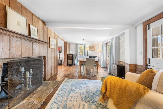 45 Main St, Essex, CT 06442 - living area with wood walls, wood-type flooring, and a fireplace