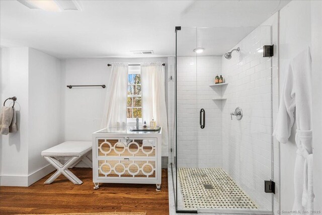 45 Main St, Essex, CT 06442 - bathroom featuring a stall shower, wood finished floors, baseboards, and visible vents
