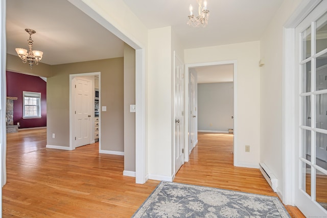 39 Overlook Dr, New Milford, CT 06776 - hall featuring baseboards, a baseboard radiator, light wood-type flooring, and a notable chandelier