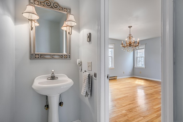 39 Overlook Dr, New Milford, CT 06776 - bathroom with an inviting chandelier, a baseboard radiator, baseboards, and wood finished floors