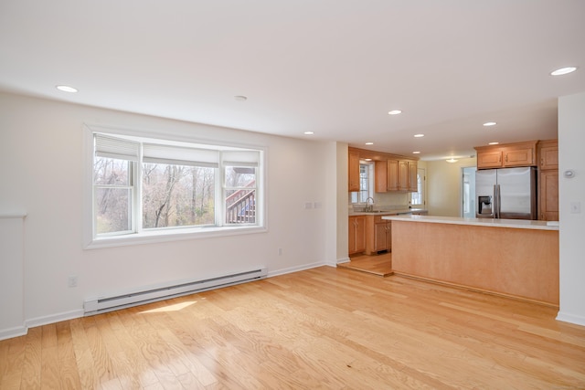 39 Overlook Dr, New Milford, CT 06776 - unfurnished living room with recessed lighting, baseboards, baseboard heating, and light wood-style flooring