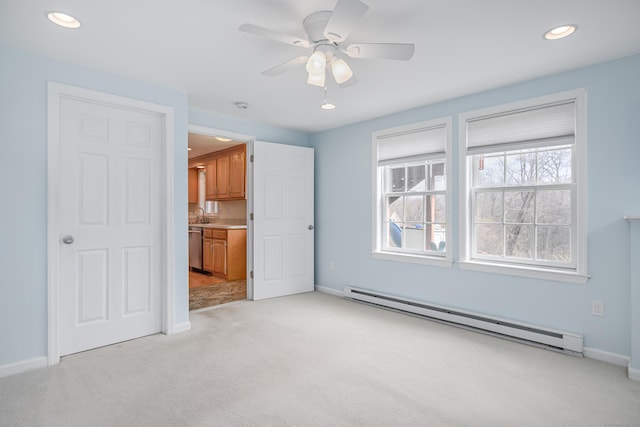 39 Overlook Dr, New Milford, CT 06776 - unfurnished living room featuring plenty of natural light, a baseboard radiator, a ceiling fan, and light carpet