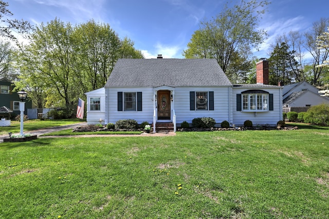 cape cod house with a chimney and a front lawn