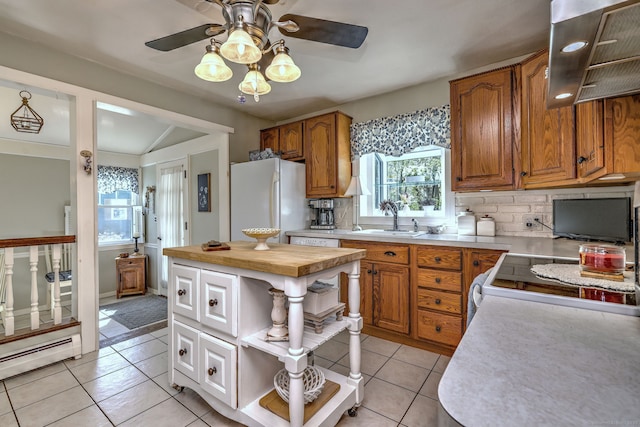 kitchen featuring wall chimney range hood, open shelves, a sink, white appliances, and a ceiling fan