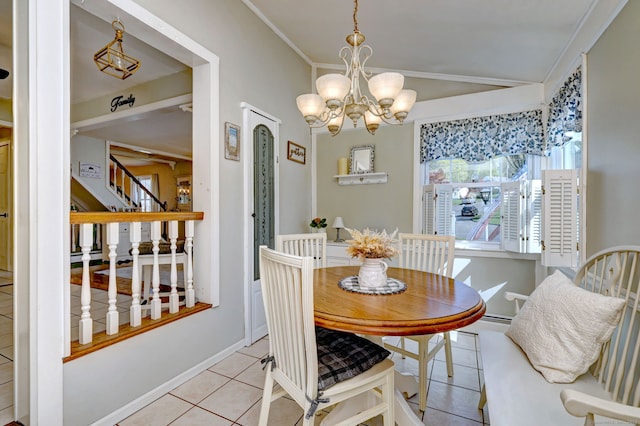 dining room featuring a chandelier, baseboards, lofted ceiling, stairs, and light tile patterned flooring