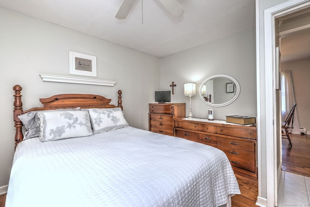 bedroom with a ceiling fan and wood finished floors
