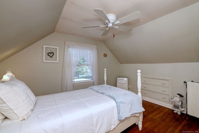 bedroom featuring a ceiling fan, wood finished floors, and vaulted ceiling