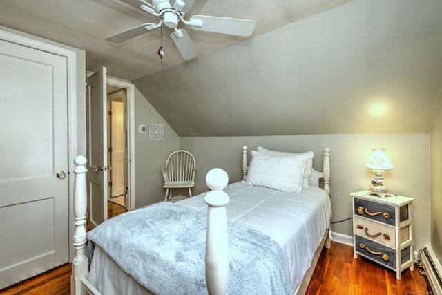 bedroom featuring baseboards, a baseboard radiator, wood finished floors, and vaulted ceiling