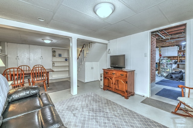 living room with stairway and finished concrete floors