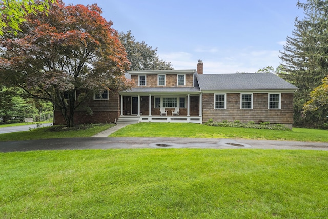 27 Blue Ribbon Dr, Westport, CT 06880 - view of front facade featuring a chimney, a front yard, covered porch, and a shingled roof