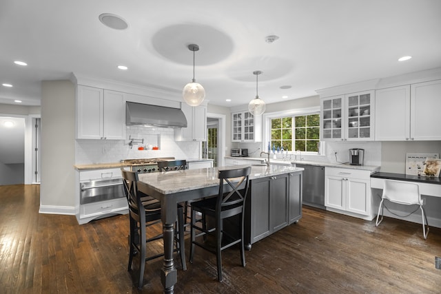 27 Blue Ribbon Dr, Westport, CT 06880 - kitchen featuring wall chimney range hood, stainless steel appliances, a warming drawer, white cabinetry, and dark wood finished floors