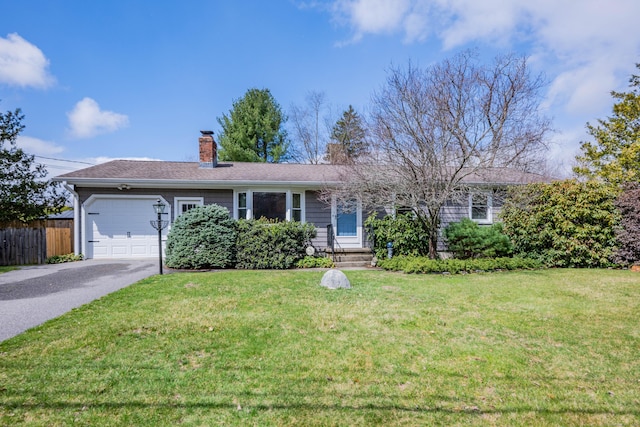 ranch-style home with a garage, a front yard, driveway, and fence
