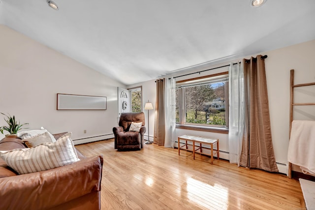 living area featuring a baseboard radiator, wood finished floors, and lofted ceiling