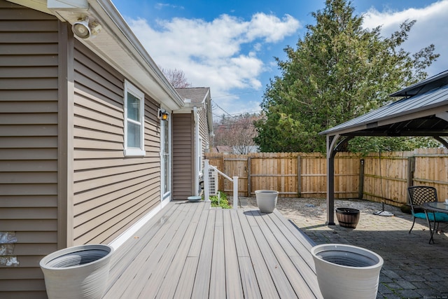 wooden deck featuring a patio and fence private yard