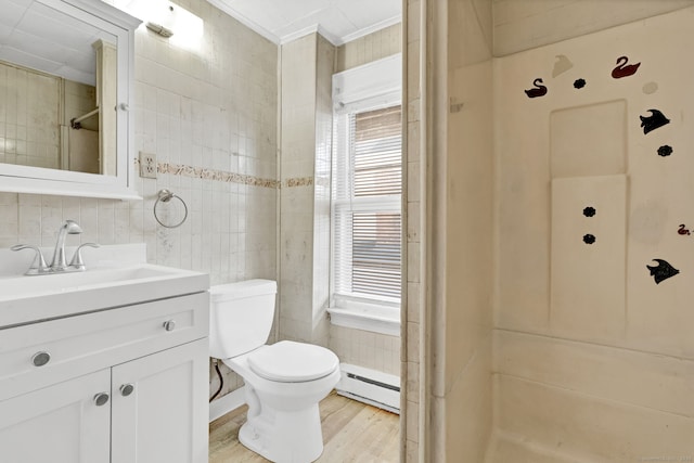 36 Gilbert St, Waterbury, CT 06702 - bathroom featuring ornamental molding, tile walls, baseboard heating, vanity, and wood finished floors