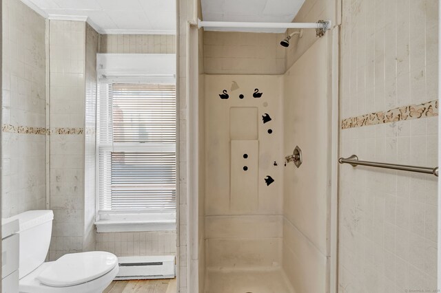 36 Gilbert St, Waterbury, CT 06702 - bathroom featuring a shower stall, baseboard heating, tile walls, and toilet