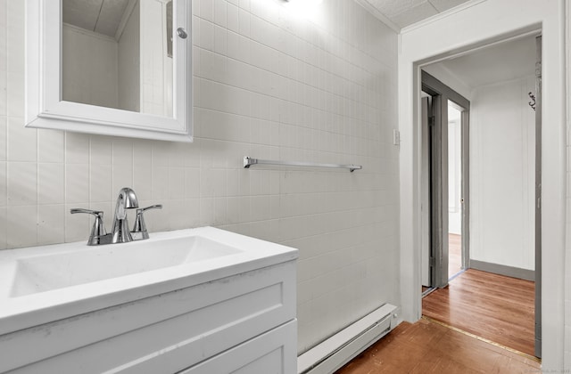36 Gilbert St, Waterbury, CT 06702 - bathroom featuring a baseboard radiator, wood finished floors, ornamental molding, and tile walls