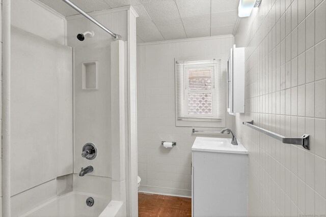 36 Gilbert St, Waterbury, CT 06702 - bathroom with vanity, ornamental molding, shower / washtub combination, toilet, and tile walls