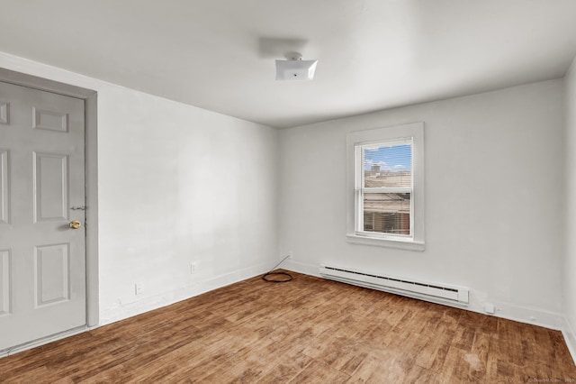 36 Gilbert St, Waterbury, CT 06702 - unfurnished room featuring baseboard heating, baseboards, and wood finished floors