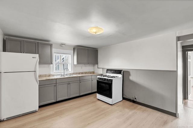 36 Gilbert St, Waterbury, CT 06702 - kitchen featuring white appliances, light countertops, gray cabinetry, light wood-style floors, and a sink