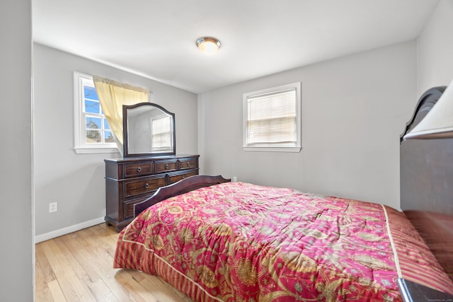 bedroom featuring baseboards and hardwood / wood-style floors