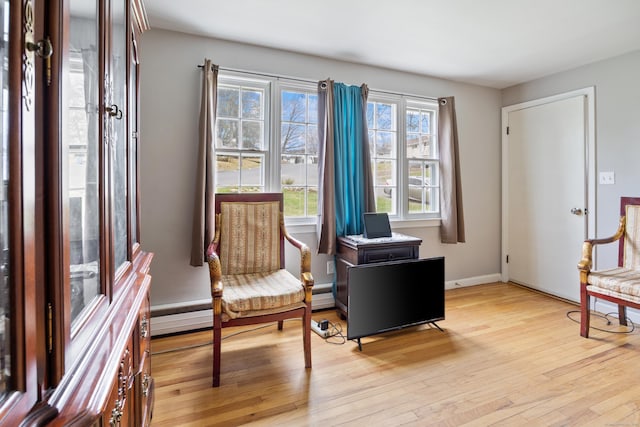 sitting room featuring light wood-style flooring and baseboards