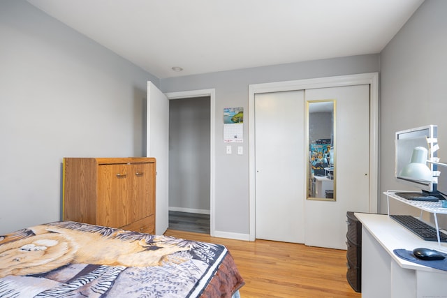 bedroom with light wood-style flooring and a closet