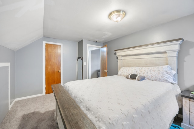 carpeted bedroom with baseboards and lofted ceiling