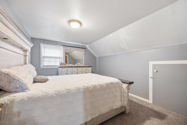 bedroom featuring carpet floors, baseboards, and lofted ceiling