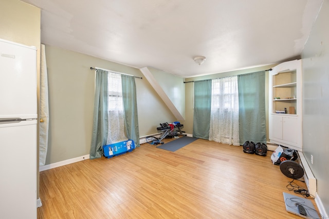 interior space featuring wood finished floors and baseboards
