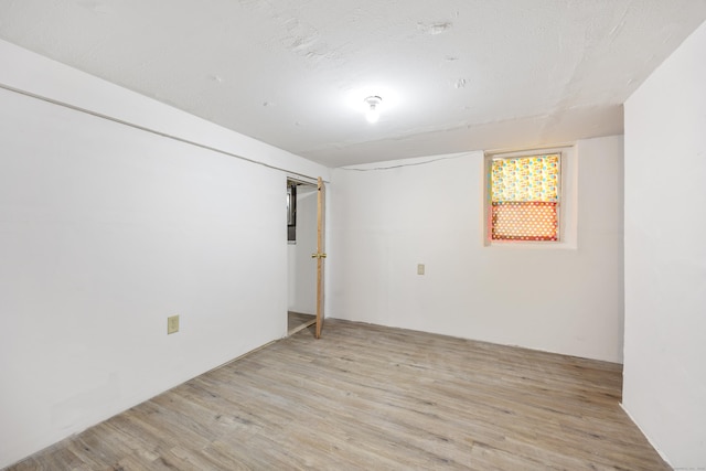 below grade area with light wood-type flooring
