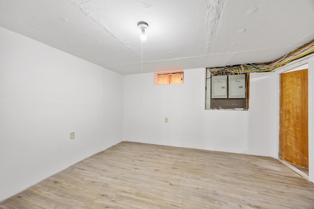 below grade area with wood finished floors and electric panel