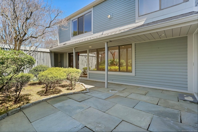 exterior space with a patio area, fence, and roof with shingles