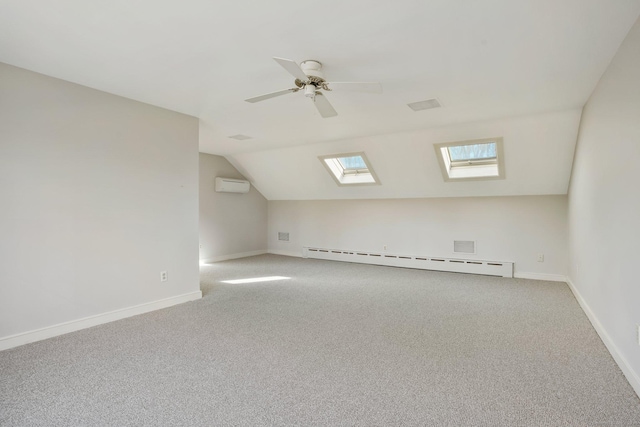 97 Wyldewood Rd, Easton, CT 06612 - additional living space with a baseboard radiator, a wall unit AC, a skylight, carpet flooring, and lofted ceiling