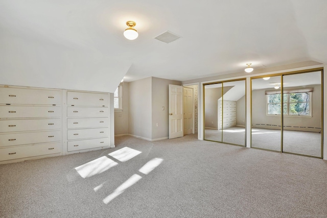 97 Wyldewood Rd, Easton, CT 06612 - unfurnished bedroom with a baseboard radiator, vaulted ceiling, two closets, light colored carpet, and multiple windows
