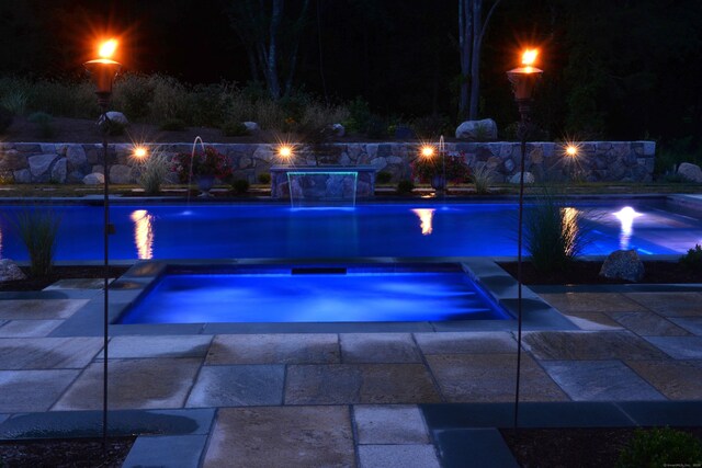 48 Mount Nebo Rd, Newtown, CT 06470 - pool at night featuring a fire pit, an outdoor pool, an in-ground hot tub, and a patio