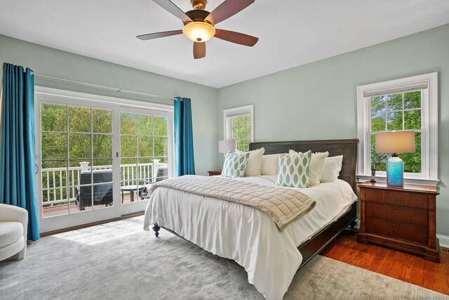 211 Linden Tree Rd, Wilton, CT 06897 - bedroom with access to outside, wood finished floors, multiple windows, and ceiling fan
