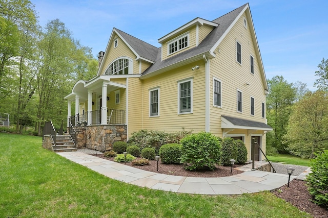 211 Linden Tree Rd, Wilton, CT 06897 - view of property exterior featuring a porch, a lawn, and roof with shingles