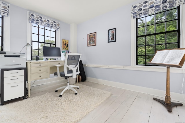 office space with light wood-style flooring and baseboards