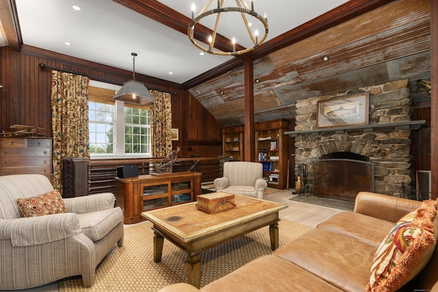 living room featuring beam ceiling, a chandelier, wood finished floors, wooden walls, and a stone fireplace