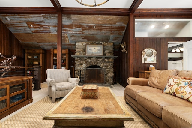 living room featuring a fireplace, wood finished floors, and wood walls