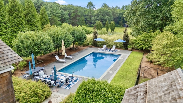 pool featuring fence and a patio