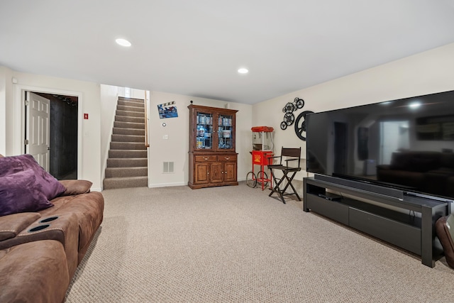 carpeted living area with stairway, baseboards, and recessed lighting