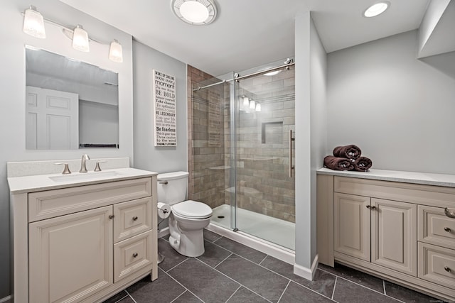 full bathroom with a stall shower, toilet, vanity, and tile patterned floors