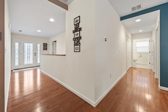 corridor with hardwood / wood-style floors, baseboards, and recessed lighting