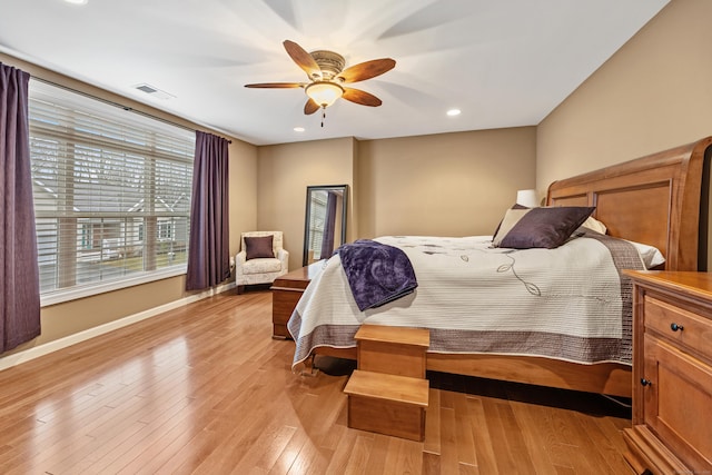 bedroom featuring light wood-type flooring, a ceiling fan, baseboards, and recessed lighting