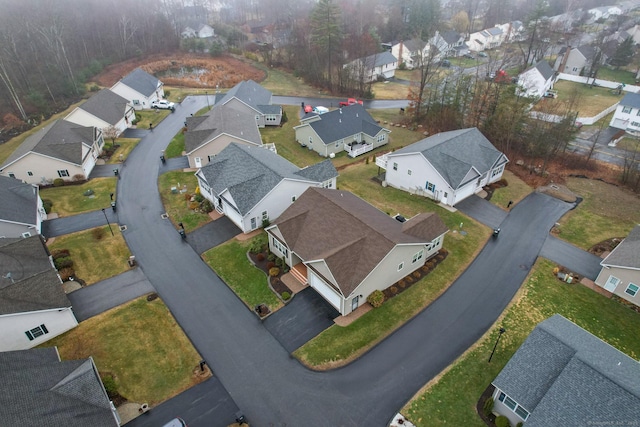 aerial view of property and surrounding area featuring nearby suburban area